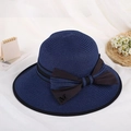 Navy blue straw sun hat with black bow and gold M charm on a clean white background - Dark Blue