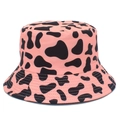 Close-up of pink bucket hat with black cow print pattern and reinforced brim stitching - Pink and Black Cow Print
