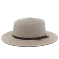 Detailed view of the woven texture and black leather strap on a beige boater hat - Gray