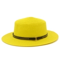 Detailed close-up of yellow straw boater hat featuring a black belt with gold rivets - Yellow