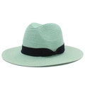 Detail of mint green straw sun hat featuring a fine weave and black ribbon bow - Mint Green