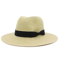 Detail of classic woven straw hat with black ribbon and bow on plain white background - Beige