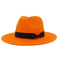 Detailed texture of bright orange straw sun hat with black ribbon and side bow accent - Orange