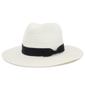 Detail view of woven straw hat featuring a black ribbon bow on a beige wide brim base - White