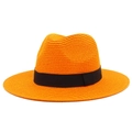 Close-up of orange woven straw sun hat with black ribbon bow and textured weave - One Size / Orange