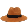 Detailed close-up of caramel straw sun hat with black grosgrain ribbon and side bow - Caramel color