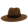 Detail of caramel straw fedora hat featuring a black ribbon bow and fine weave texture - Coffee