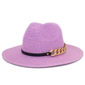 Detailed texture of purple straw fedora hat featuring a bold gold chain and black band - Purple