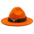 Detail of orange wool cowboy hat featuring a black leather band and metal bull head emblem - Orange