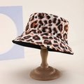 Classic leopard print bucket hat with a flat top and wide brim on a wooden display stand - Beige Brown Black Tri-Color Leopard (42)