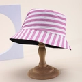 Pink and white striped bucket hat on a wooden stand with a minimalist studio background - Pink White Staggered Stripes (47)