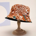 Detailed close-up of orange and white bohemian pattern bucket hat on a wooden stand - One Size / Orange White Bohemian (Color 3)