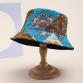 Detailed close-up of a bohemian bucket hat with blue mandala prints on a wooden stand - Sky Blue Chocolate Brown Mandala Patchwork (96)