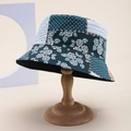Close-up of patterned bucket hat with floral and polka dot patchwork on a wooden stand - Dark Cyan Floral Dots Geometric Patchwork (25)