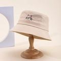 Beige cotton bucket hat featuring a cute cat embroidery on a wooden stand - One Size / Khaki