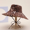 Detailed view of leopard print sun hat with wavy brim and tie strap on a wooden stand - Brown Leopard Print Style (9#)