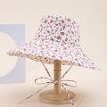 Detail of floral bucket hat with pink flower pattern and delicate ribbon bow on stand - White With Pink Floral Style (15#)