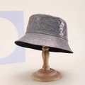 Iridescent silver PU leather bucket hat with metallic glitter finish on a wooden stand - One Size / Silver AB