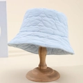 Light blue padded heart quilted bucket hat for women on wooden stand for autumn winter - Blue