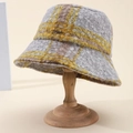Classic yellow and grey plaid fleece bucket hat for women on a wooden display stand - Yellow