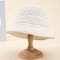 Off-white heart quilted bucket hat for women on a wooden stand for autumn and winter - White