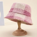 Pink and beige checkered wool bucket hat for women on a wooden display stand - Pink