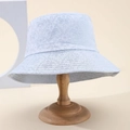 Stylish light blue bucket hat with floral butterfly embroidery on wooden stand - Blue