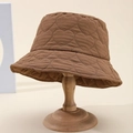 Brown heart-pattern quilted bucket hat for women on vintage wooden stand - Coffee