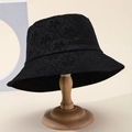 Women's black lace floral embroidery bucket hat displayed on a wooden stand - Black