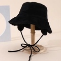 Black faux suede fisherman hat with ear flaps and warm plush lining on a stand - One Size / Black