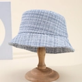 Blue-grey tweed plaid bucket hat with frayed edges on a wooden stand for women - Blue