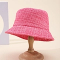 Classic rose pink tweed bucket hat for women on a wooden stand with a textured weave - Rose Red