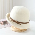 Elegant cream white wool felt cloche hat with a brown leather buckle on a wooden stand - One Size / White