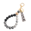 Detail of beaded keychain bracelet with silicone beads, wooden hex bead and leather tassel - Black and White Spots (43769-BC0805)