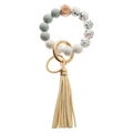 Detail of silicone beaded keychain with wood hexagon eye bead, gold ring and beige tassel - White Gray Terrazzo