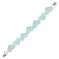 Close-up of heart-shaped jelly beads in light blue with transparent coating and metal clasp - Blue