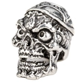 Macro shot of vintage silver skull bead featuring detailed engravings for hair or jewelry - Viking Smooth Skull Style