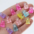 Close-up of assorted resin gummy bear charms with glitter filling held in palm - Colorful Sequin Bear Mix