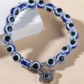 Handgefertigtes blaues Harz-Armband mit bösem Blick und Vintage-Silberschmetterling - Blauer Schmetterling
