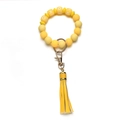 Detail of yellow silicone beaded keychain featuring leather tassel and gold metal hardware - OXOX Yellow Beaded Tassel Keychain