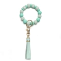 Detailed macro view of mint green silicone beads with XOXO square accents and a silk tassel - OXOX Gray Green Beaded Tassel Keychain