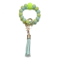 Detailed macro of gradient green silicone bead keychain with gold hardware and blue tassel - Gradient Green