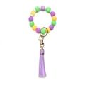 Detail view of colorful silicone beaded keychain with XOXO blocks and long purple tassel - OXOX Purple Green Yellow Beaded Tassel Keychain
