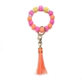 Close-up of silicone beaded keychain with XOXO letters, orange tassel and gold clasp - OXOX Purple Orange Yellow Beaded Tassel Keychain