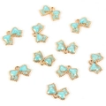 Macro shot of ten light blue enamel bow charms with golden metal edges for DIY jewelry making - Bow Tie / Blue
