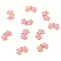 Detailed view of ten pink enamel bow charms with golden edges for DIY jewelry making - Bow Tie / Rose Red
