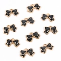 Detail of ten black glitter bow pendants with golden alloy edges for jewelry DIY - Bow Tie / Black