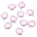 Detailed view of faceted pink crystal round charms with silver metal connectors for DIY jewelry - Pink