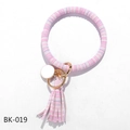 Close-up of pink and white striped PU leather keychain bracelet with tassel and gold clasp - Pink White Stripes (BK-019)