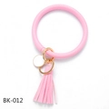 Close-up of pink PU leather bangle keychain with golden ring and soft long tassel detail - Solid Pink (BK-012)